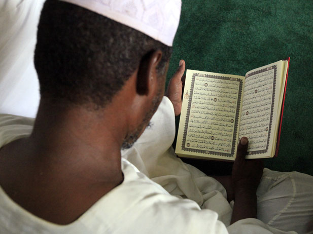 A Muslim man reads the Koran on the second day of Ramadan in Khartoum (Mohamed Nureldin Abdallah/Courtesy Reuters)