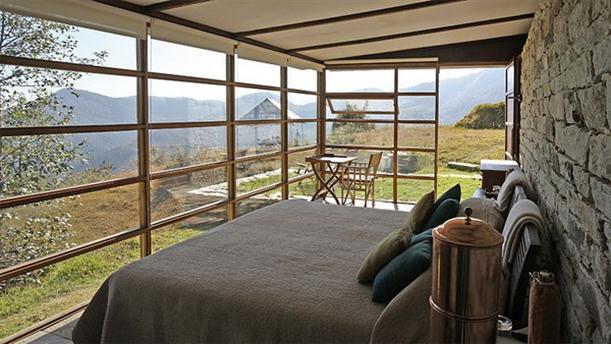 Master Bedroom at Mountain Home Design Features Stone and Glass Wall