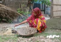 Young woman cooks eggs in Assam, India