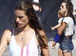 Life's a beach! Alessandra Ambrosio displays her slender legs in dungarees as she totes son Noah on family day out