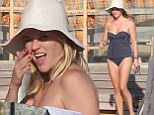 Reese Witherspoon shows off her bikini body as she hits the beach in a polka dot peplum two-piece for Independence Day