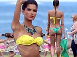 That's a bit cheeky! Victoria's Secret model Raica Oliveira flies the flag for Brazil as models a VERY high cut Brazilian bikini 
