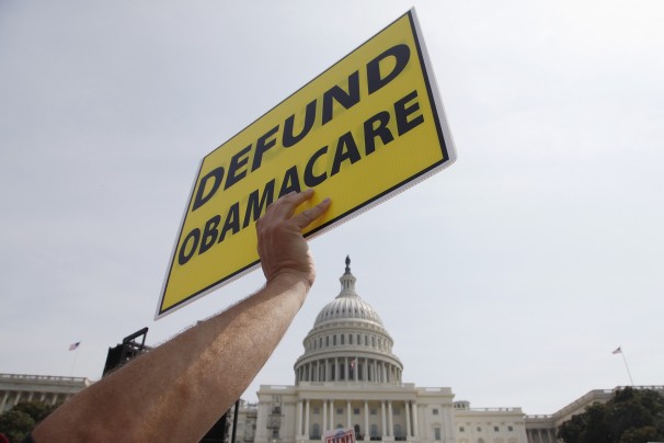 A man holds a sign at the Tea Party Patriots 'Exempt America from Obamacare' rally on the west lawn of the U.S. Capitol in Washington, September 10, 2013. REUTERS/Jonathan Ernst (UNITED STATES - Tags: POLITICS HEALTH CIVIL UNREST)