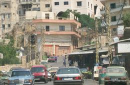 The entrance to Syria Street from behind the Bab Al Tabbaneh market. The apartment buildings on the hill serve as sniper spots for gunfire into Jebel Mohsen. // Source: Nicholas A. Heras