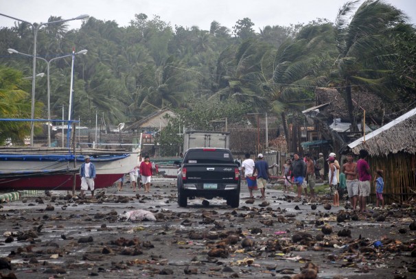 Debris litter the road by the coastal village in Legazpi, about 325 miles south of Manila. 