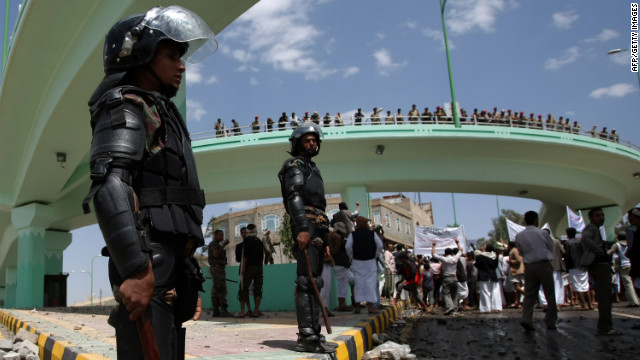 Yemeni riot policemen stand guard at a crossroad leading to the U.S. Embassy in Sanaa on Friday.