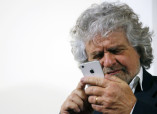 The 5-Star Movement leader and comedian Grillo checks his iPhone before a news conference for foreign press in downtown Rome