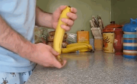 Pinching the end of a banana is a far easier way to open it.