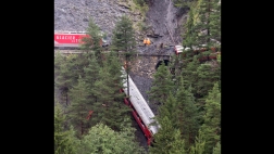 A passenger train in Switzerland has derailed in what police are calling a “serious accident,” as several cars are hanging over a steep wooded area.