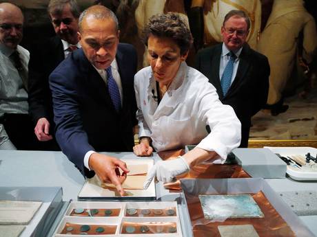Massachusetts Governor Deval Patrick (L) and Hatchfield look at artefacts removed from the capsule
