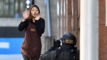 Woman runs out of building during siege in Sydney's Martin Place