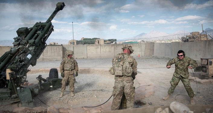 This photo taken on May 28, 2014 shows US Army Sergeant (retired) Joshua Ben, of Missouri (R) who lost his leg to an Rocket Propelled Grenade (RPG) in Afghanistan’s Jalrez Valley in 2007, firing artillery during 'Operation Proper Exit' at Forward Operating Base Shank in Afghanistan's Logar Province