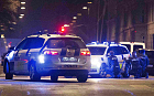 Police personnel and vehicles are seen along a street in central Copenhagen, early February 15, 2015