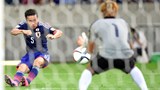 Japan's defender Yuto Nagatomo (L) shoots the ball in front of Cambodia's goalkeeper Sou Yaty (R) 