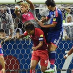 Japan's defender Masato Morishige fights for the ball with Cambodia's goalkeeper Sou Yaty