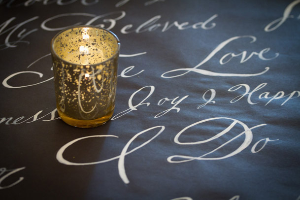 gold tea light black calligraphy runner table
