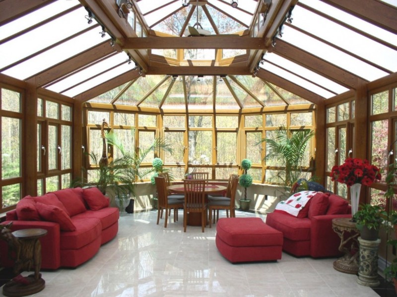 zen sunroom with massive glass screens and round dining set