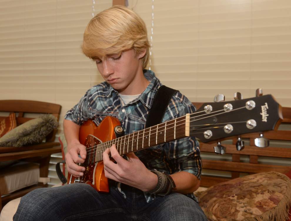 Advocate staff photo by PATRICK DENNIS -- Guitar prodigy 13-year-old Quentin 'Q-Tip' Faulkner, practicing in his Prairieville home, will be playing the national anthem before Thursday's Pelicans game. 