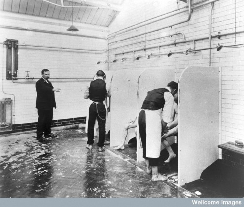 Male patients being washed by attendants at Epsom's Long Grove Asylum, c.1930. © Wellcome Library, London