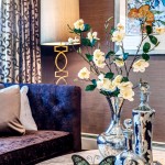 bohemian interior design with pattern curtain and adorable floor lamp and orchid and black sofa and wallpaper