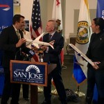 International Airlines Group CEO Willie Walsh presents San Jose Mayor Sam Liccardo with a gift from British Airways: a model Boeing 787-9 Dreamliner airplane.