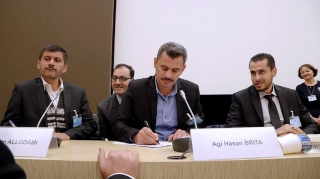 Hagi Hasan Brita, president of the civil committee of Aleppo (C), Abdulrahman Almawwas (R), vice-president of the Syrian White Helmets, and Tammam Allodami, a member of the White Helmets, take part in a meeting at the National Assembly in Paris on October 18, 2016. (AFP PHOTO/FRANCOIS GUILLOT)