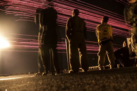 PACIFIC OCEAN (Dec. 9, 2015) U.S. Marines with the 15th Marine Expeditionary Unit and Sailors with the Essex Amphibious Ready Group watch a &#39;fireworks&#39; weapons display with their family members on the flight deck of amphibious assault ship USS Essex (LHD 2). The family members are on a Tiger Cruise from Hawaii back to California to experience the day-to-day life of their Marines and Sailors. (U.S. Marine Corps photo by Sgt. Elize McKelvey/Released)