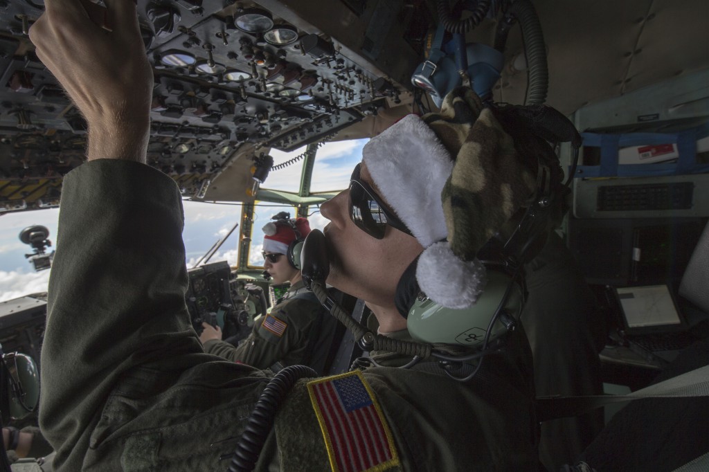 Staff Sgt. Travis Livingston, 36th Airlift Squadron flight engineer, checks instruments over the Pacific Ocean, Dec. 11, 2015, during Operation Christmas Drop. Every December, C-130H Hercules aircrews from Yokota head to Andersen Air Force Base to execute low-cost, low-altitude humanitarian airdrops to islanders throughout the Commonwealth of the Northern Marianas, Federated States of Micronesia, Republic of Palau. These islands are some of the most remote locations on the globe spanning a distance nearly as broad as the continental U.S. It is the longest-running Department of Defense humanitarian airdrop operation with 2015 being the first trilateral execution with support from Japan Air Self-Defense Force and Royal Australian Air Force. (U.S. Air Force photo by Osakabe Yasuo/Released)