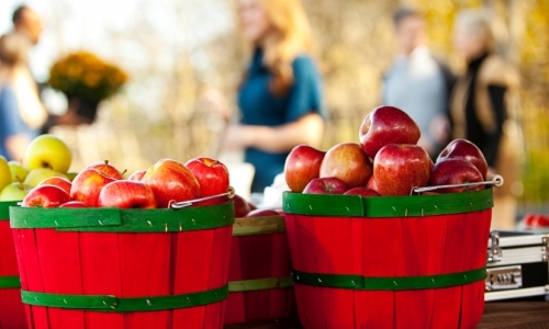 Two baskets of red apples at a farmers market. (iStock)