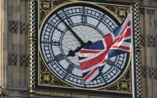 A Union Flag flies in front of the clockface of Elizabeth Tower on March 13, 2017