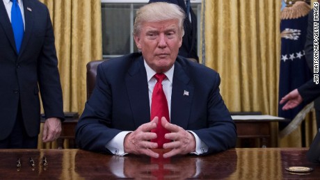 US President Donald Trump (C) waits at his desk before signing confirmations for James Mattis as US Secretary of Defense and John Kelly as US Secretary of Homeland Security, as Vice President Mike Pence (L) and White House Chief of Staff Reince Priebus (R) look on, in the Oval Office of the White House in Washington, DC, January 20, 2017. / AFP / JIM WATSON        (Photo credit should read JIM WATSON/AFP/Getty Images)