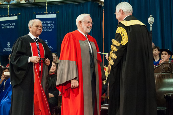 University of Toronto Chancellor Michael Wilson confers an honorary degree upon Arthur McDonald, the winner of the 2015 Nobel Prize in Physics on Thursday, June 8.