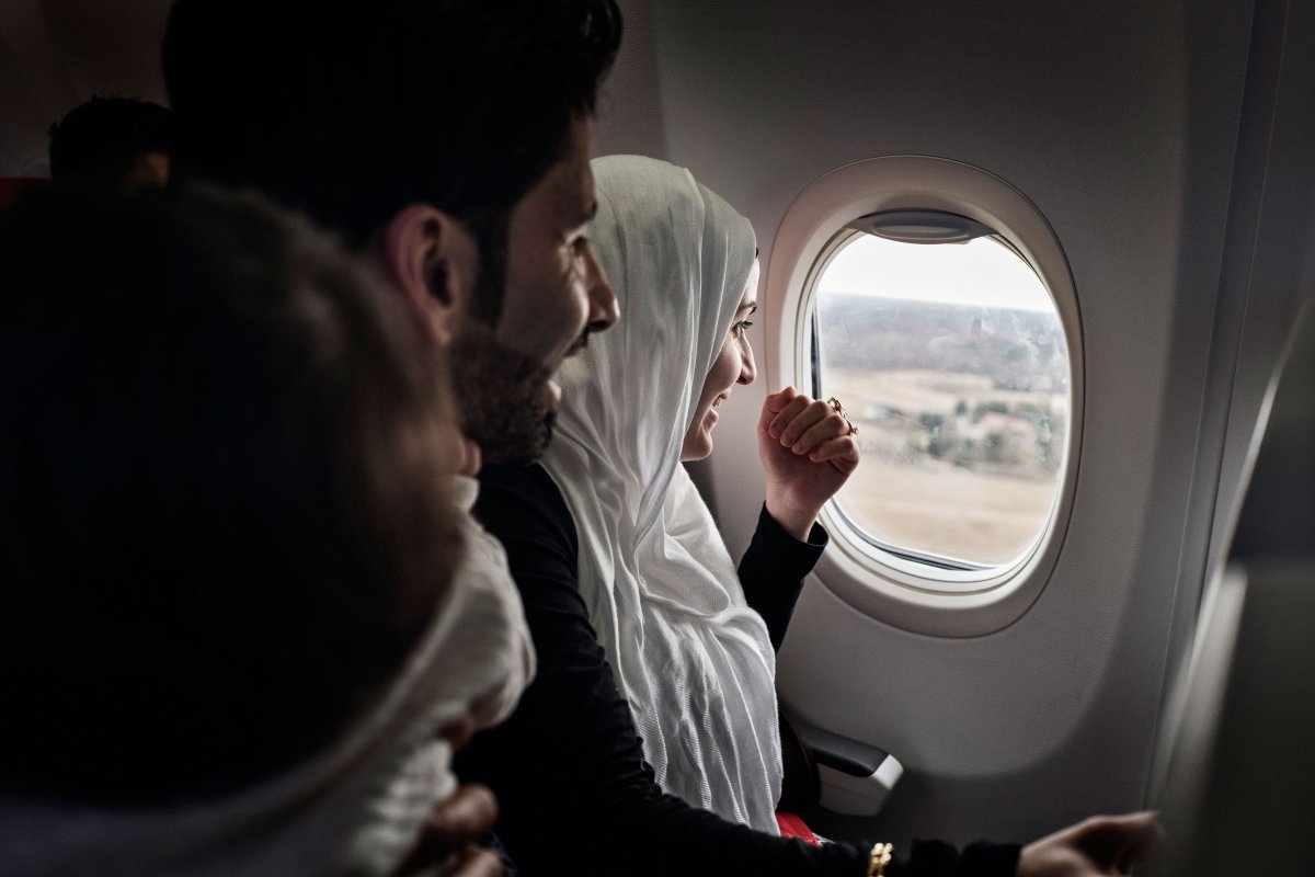 Taimaa on the plane with husband Mohannad and their children. Wael and Heln, on the first airplane flight of their lives arriving in Estonia’s capital, Tallinn. Lynsey Addario—Verbatim for TIME