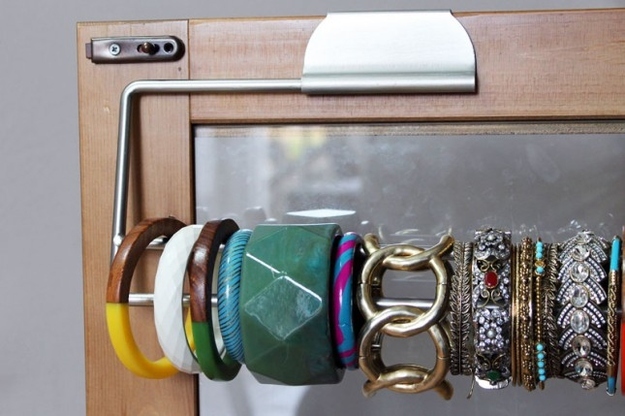 Display bracelets on a paper towel holder to keep them organized.