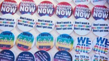 An assortment of colourful badges saying slogans like "marriage equality NOW" and "Say yes to gay marriage".