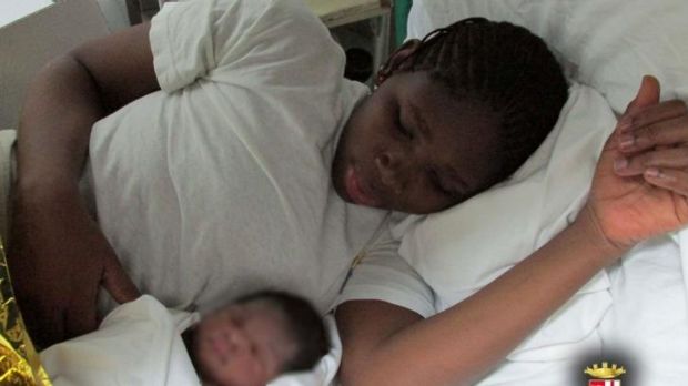 A Gambian migrant rests with her baby daughter Yambambi Yete after giving birth aboard an Italian navy frigate near ...