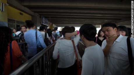 Commuters wait to enter a subway station during the morning rish hour in Beijing on June 19, 2013. Despite some five million private vehicles in Beijing, public transport faces heavy congestion on a daily basis as most of the city&#39;s 20 million people head to work. AFP PHOTO / Ed Jones        (Photo credit should read Ed Jones/AFP/Getty Images)