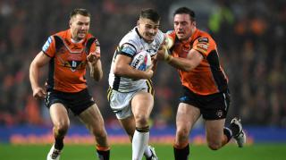 Rhinos on the charge: Stevie Ward of Leeds muscles past Michael Shenton, left, and Grant Millington of Castleford Tigers in last night’s Grand Final
