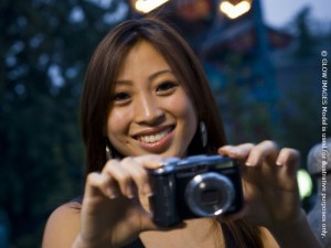 Woman taking a photograph smiling format