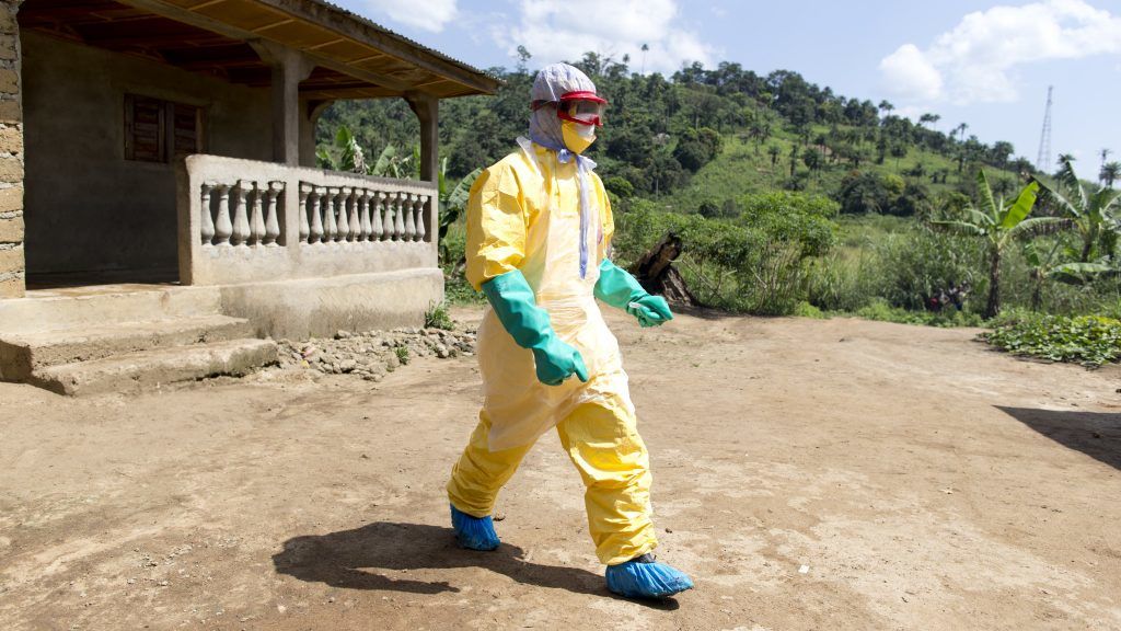 An health worker from Guinea's Red Cross wearing a Personal Protective Equipments (PPE) leaves the house of a victim of the Ebola virus in Patrice disitrict in Macenta, in Guinea on November 21, 2014.  The deadliest Ebola epidemic on record has killed more than 5,000 people in west Africa and infected almost three times that number, according to the World Health Organization. The virus emerged in Guinea at the start of the year and has infected around 1,900 Guineans, killing almost 1,200.
AFP PHOTO KENZO TRIBOUILLARD / AFP PHOTO / KENZO TRIBOUILLARD