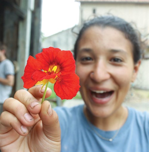 student holding a flower