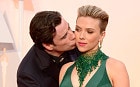 John Travolta kisses Scarlett Johansson as they arrive for the 87th annual Academy Awards ceremony at the Dolby Theatre in Hollywood, California