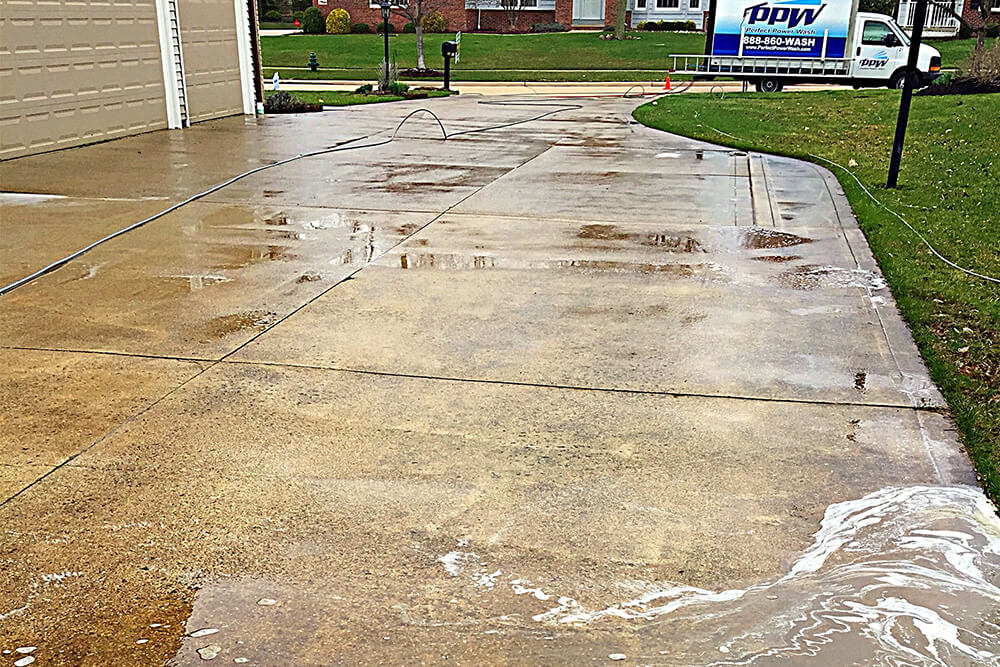 dirty driveway before pressure washing it clean