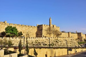 The walls of the eternal Jerusalem at sunset. Warm evening light illuminates the ancient walls and Tower of David