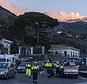 Italian Civil protection volunteers gather near the heavily damaged church of Maria Santissima as plumes of smoke come out the Mount Enta Volcano in Fleri, Sicily Italy, Wednesday, Dec. 26, 2018. A quake triggered by Italy's Mount Etna volcano has jolted eastern Sicily, slightly injuring 10 people and prompting frightened Italian villagers to flee their homes. (AP Photo/Salvatore Allegra)