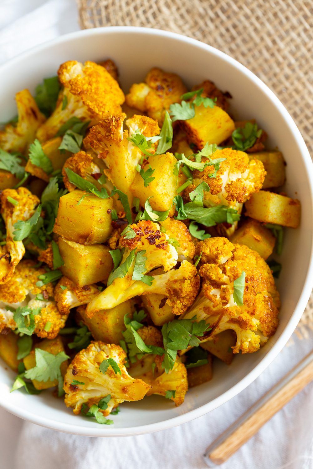 Baked Aloo Gobi - Indian Spiced Potato Cauliflower Bake. 10 Mins Active. Toss with spices, put it to bake, and done! No Standing around, no Mushy Cauliflower! Same Amazing Indian flavor and excellent texture. Tips to make the Best Aloo Gobi Subzi that bakes perfectly every time! #Vegan #Glutenfree #Soyfree #Nutfree #VeganRicha #aloogobi #Recipe