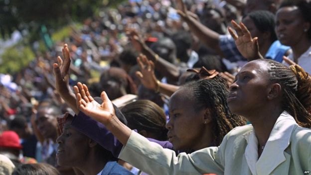 Worshipers raise their hands 01, October 2005 during a gospel meeting by visiting US Bishop, Thomas Dexter Jakes in Nairobi , Kenya