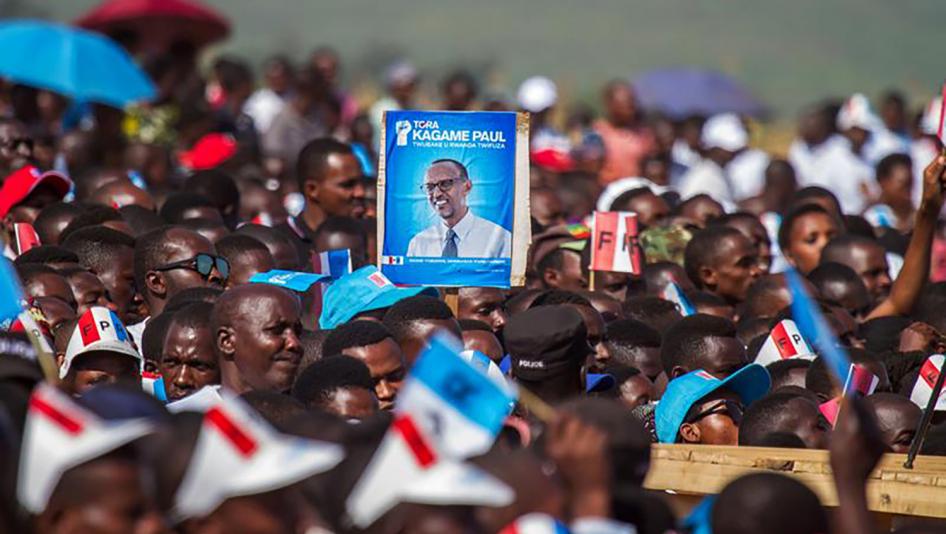 Supporters of Rwandan President Paul Kagame of the ruling Rwandan Patriotic Front (RPF) carry his portrait as they attend the final campaign rally in Kigali, Rwanda, August 2, 2017.