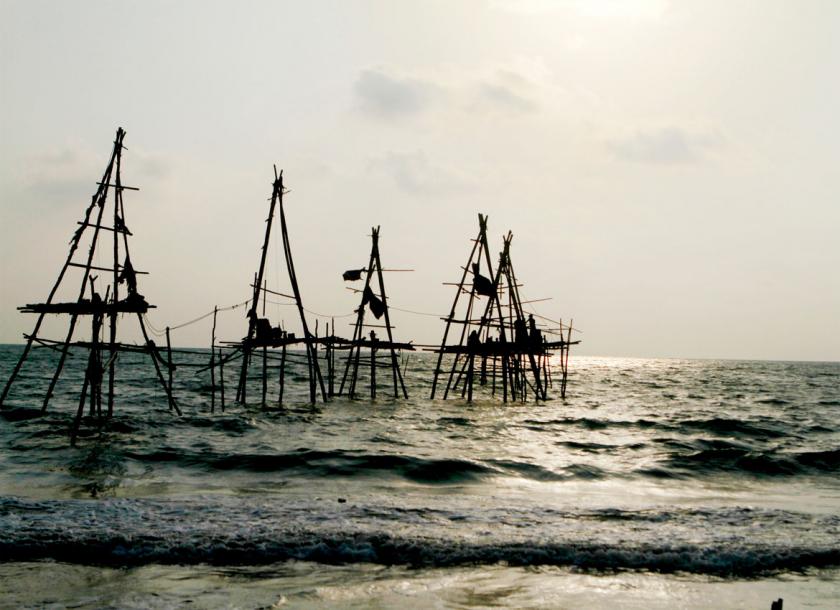 Locals set up makeshift oil rigs at the Kyaukphyu shoreline in 2014. Photo - EPA