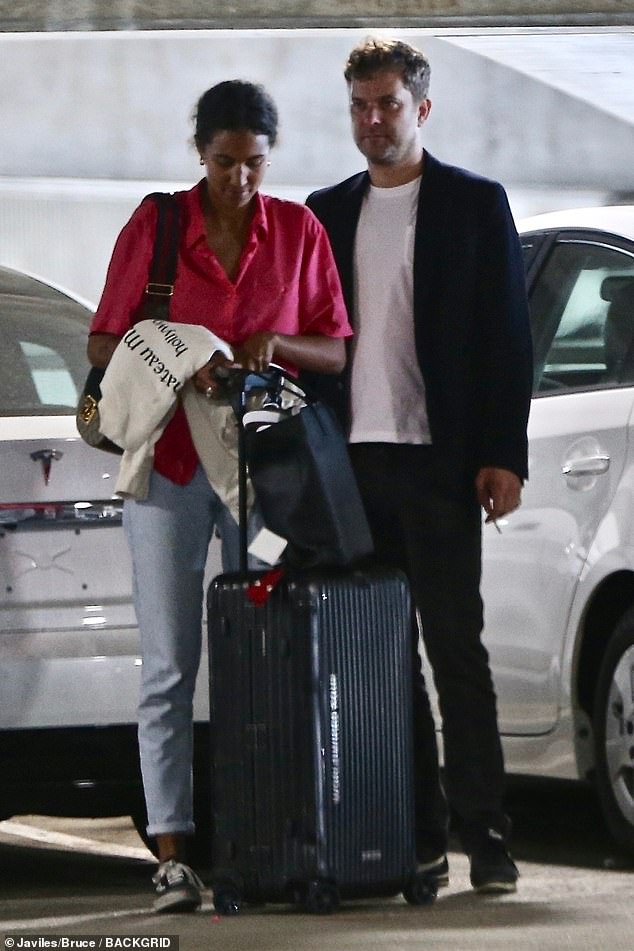 A mystery: The duo apparently shared a cigarette before he escorted her to the terminal for her flight